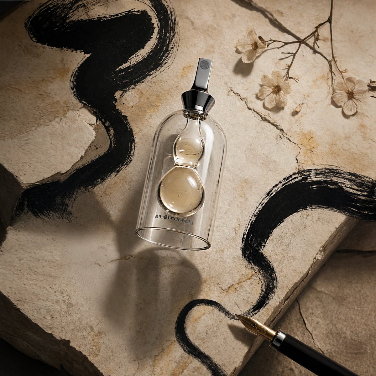 Albatre Sepia bottle flat-lay on travertine stone with ink strokes and magnolia
